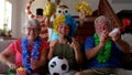 Group of crazy and coloured football supporter celebrate and exult during the match - mixed ages of caucasian people family and