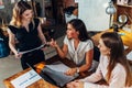 Group of creative female designers working on a new project together talking, discussing, suggesting ideas sitting in Royalty Free Stock Photo