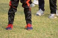 Cricketers legs wearing trousers & shoes stock photograph