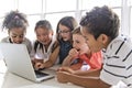 Group of curious children watching stuff on the laptop screen