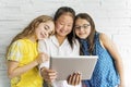 Group of curious children watching stuff on the tablet screen