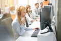 Group of customer service operators working in row in call center office. Royalty Free Stock Photo