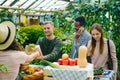 Group of customers choosing organic food in market talking to sales woman