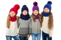 Group of cute kids in winter warm hats and scarfs on white. Children winter clothes Royalty Free Stock Photo