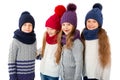 Group of cute kids in winter warm hats and scarfs on white. Children winter clothes Royalty Free Stock Photo