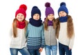 Group of cute kids in winter warm hats and scarfs on white. Children winter clothes Royalty Free Stock Photo