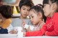 Group of Cute little girl student painting a ceramic pottery model  in classroom school . kid artist . child sitting at desk Royalty Free Stock Photo