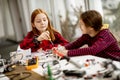 Cute little girls programming electric toys and robots at robotics classroom