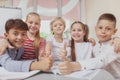 Group of cute little kids drawing together in art class