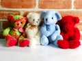 A group of cute teddy bears sitting together against with wallpaper Royalty Free Stock Photo
