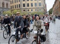 Group of cycling people wearing old fashioned tweed clothes