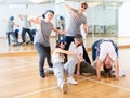 Group of dancing teenagers posing in dance studio Royalty Free Stock Photo