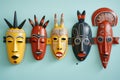 a group of decorative african masks set against a bright wall Royalty Free Stock Photo