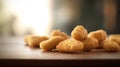 Group of deep fried chicken nuggets on a wooden board with blurred background.