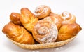 Group of delicious cinnamon rolls in basket isolated