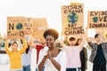 Group demonstrators protesting against plastic pollution and climate change - Multiracial people fighting on road holding banners