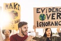 Group demonstrators protesting against plastic pollution and climate change - Multiracial people fighting on road holding banners