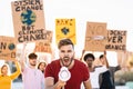 Group demonstrators protesting against plastic pollution and climate change - Multiracial people fighting on road holding banners Royalty Free Stock Photo
