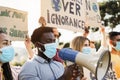 Group of demonstrators on road from different culture and race protest for climate change during coronavirus outbreak - Focus on