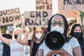 Group of demonstrators on road from different cultures protest for equal rights - Focus on african senior woman Royalty Free Stock Photo