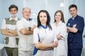 Group of dentists standing in their office and looking at camera.