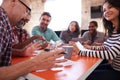 Group Of Designers Having Meeting Around Table In Office Royalty Free Stock Photo