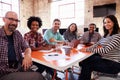 Group Of Designers Having Meeting Around Table In Office Royalty Free Stock Photo