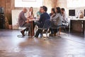 Group Of Designers Having Meeting Around Table In Office Royalty Free Stock Photo