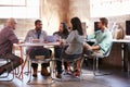 Group Of Designers Having Meeting Around Table In Office Royalty Free Stock Photo