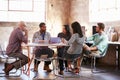 Group Of Designers Having Meeting Around Table In Office Royalty Free Stock Photo