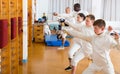 Group of different ages fencers practicing fencing