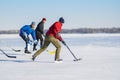 Group of different ages ordinary people playing hockey on a Dnipro river in Dnipro city, Ukraine