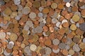 Group of different coins scattered on a flat surface Royalty Free Stock Photo