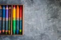 a group of different colored crayons sit in a wooden box Royalty Free Stock Photo