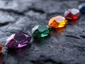 A group of different colored gems sitting on top of a rock Royalty Free Stock Photo