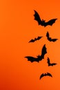 Few black paper bats on orange with copy space Royalty Free Stock Photo