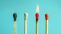 Group of different matches, some burning, pastel blue background, leadership, idea generation, teamwork. Generative AI Royalty Free Stock Photo