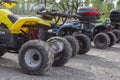 A group of dirty electric quads in an outdoor parking