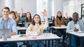 Portrait of diverse students raising hands at classroom Royalty Free Stock Photo