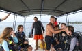 Group of divers from diving center on a boat swim to the dive site, young boys and girls, an adult instructor, Asia Sri Lanka Royalty Free Stock Photo