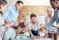 Group of diverse architects discussing plans, blueprints and schematics during a meeting in their office boardroom Royalty Free Stock Photo