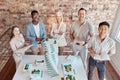 Group of diverse architects discussing plans, blueprints and schematics during a meeting in their office boardroom Royalty Free Stock Photo