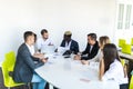 Group of diverse business executives holding a meeting around a table discussing graphs showing statistical analysis. Team work Royalty Free Stock Photo