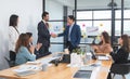 Group of diverse business people shaking hands, finishing up a deal or meeting. Businessman and businesswoman in formal suits Royalty Free Stock Photo