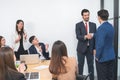 Group of diverse business people shaking hands, finishing up a deal or meeting. Businessman and businesswoman in formal suits Royalty Free Stock Photo