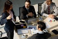 A Group of diverse businesspeople, Asan and Caucasian, make a conference together at the desk. Idea for good team at workplace