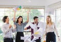 Group of diverse businesspeople, caucasian and Asian, throwing paper in to the air. Idea for teamwork and good business colleagues