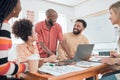 Group of diverse businesspeople having a meeting in a modern office at work. Young cheerful african american businessman Royalty Free Stock Photo