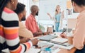 Group of diverse businesspeople having a meeting in a modern office at work. Young serious caucasian businesswoman Royalty Free Stock Photo