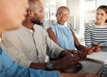 Group of diverse businesspeople having a meeting in an office at work. Business professionals talking while using a Royalty Free Stock Photo